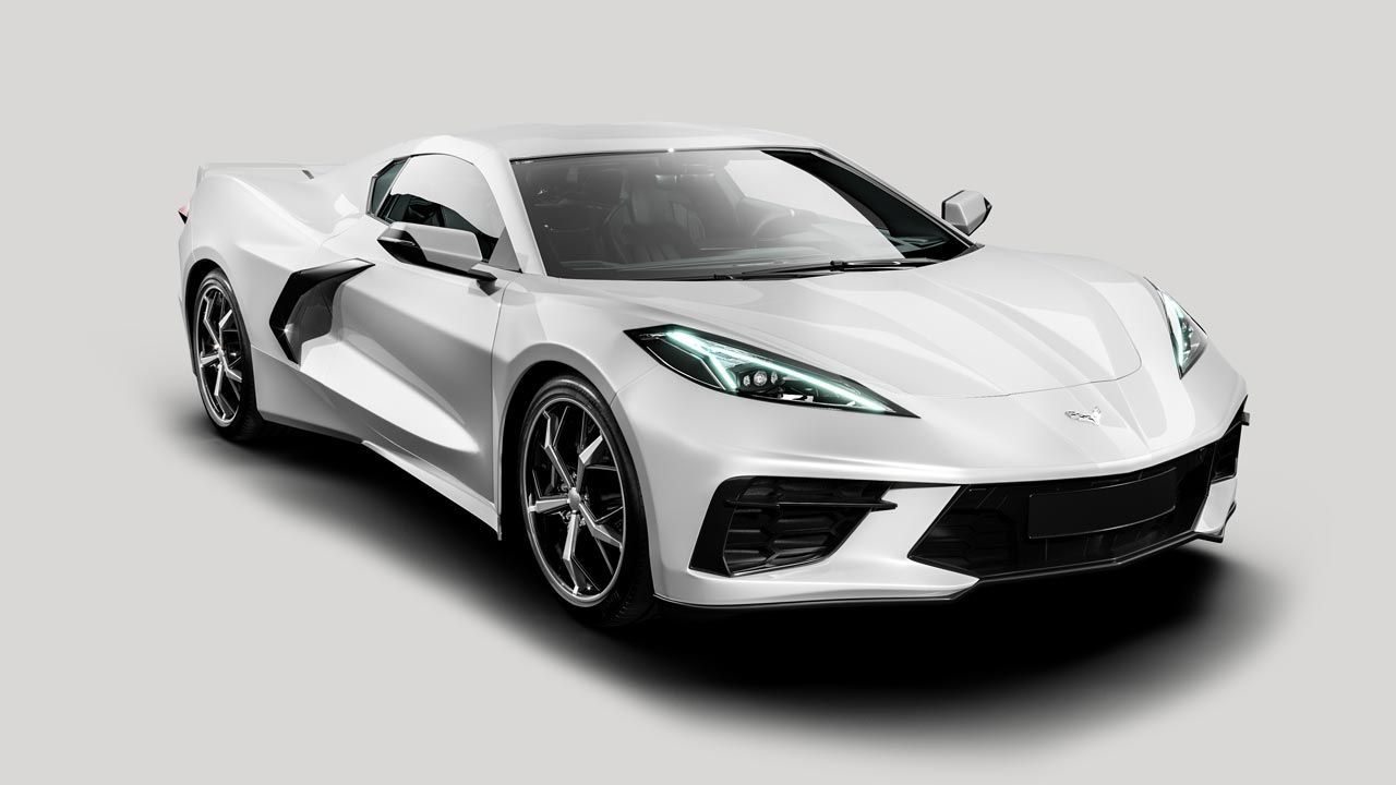A white corvette sports car is sitting on a white surface.