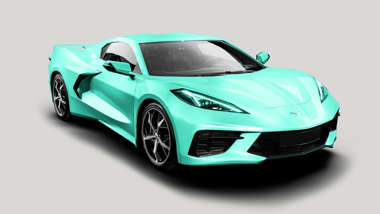 A light blue sports car is sitting on a white surface.