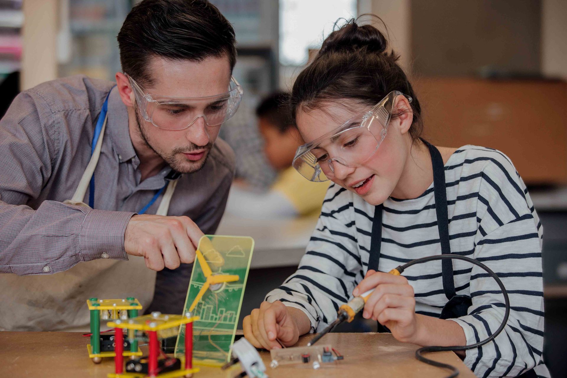 A man and a girl are working on a project together.