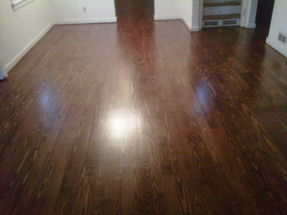 A living room with a wooden floor and white walls.