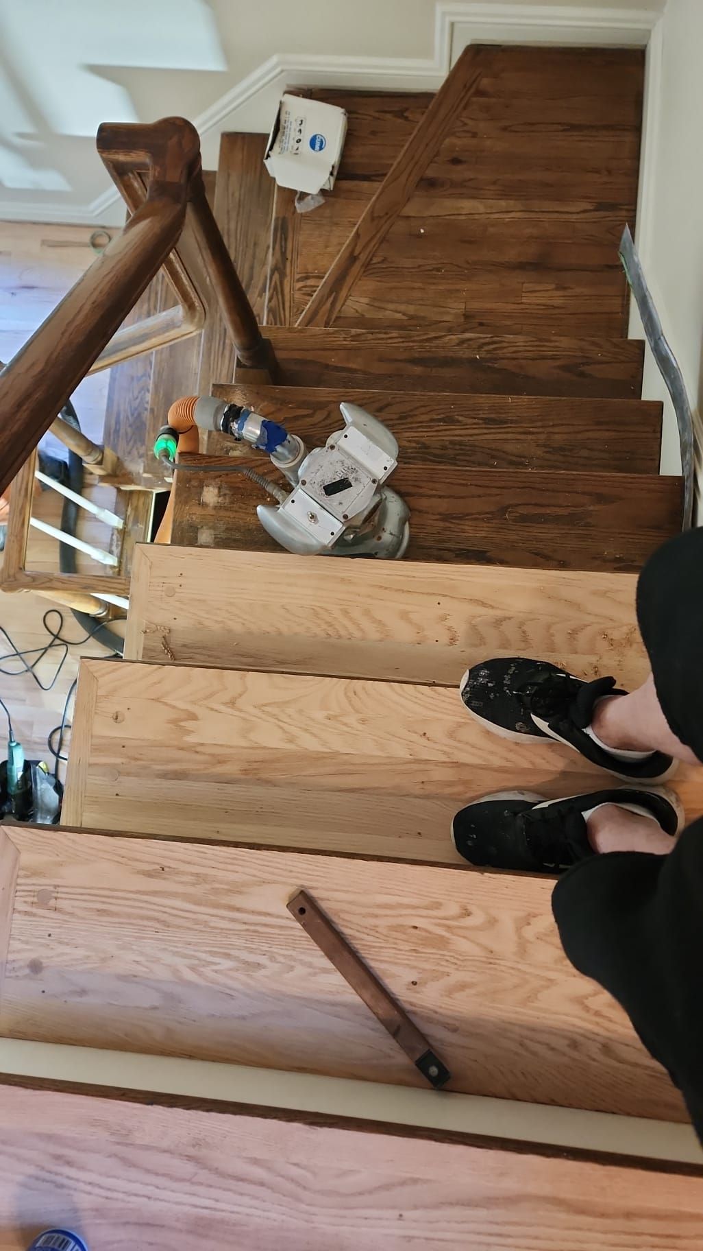 A person is standing on a set of wooden stairs.