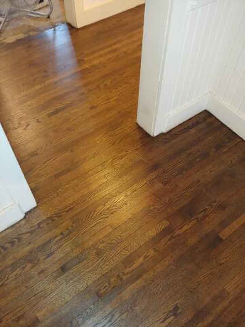 A close up of a wooden floor in a room.