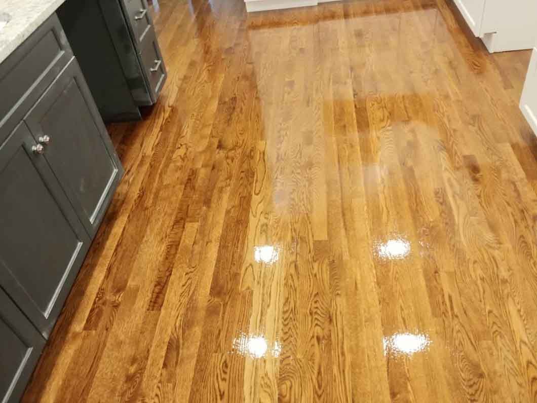 A kitchen with hardwood floors and gray cabinets.