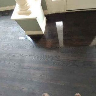 Person is Standing on a Dark Wooden Floor in a Living Room