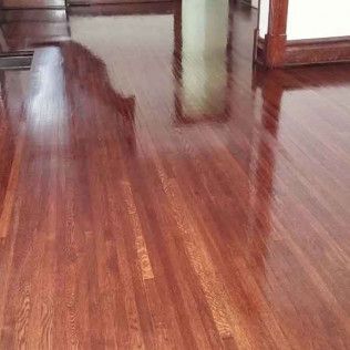 A Wooden Floor in a Living Room With a Pillar in the Background