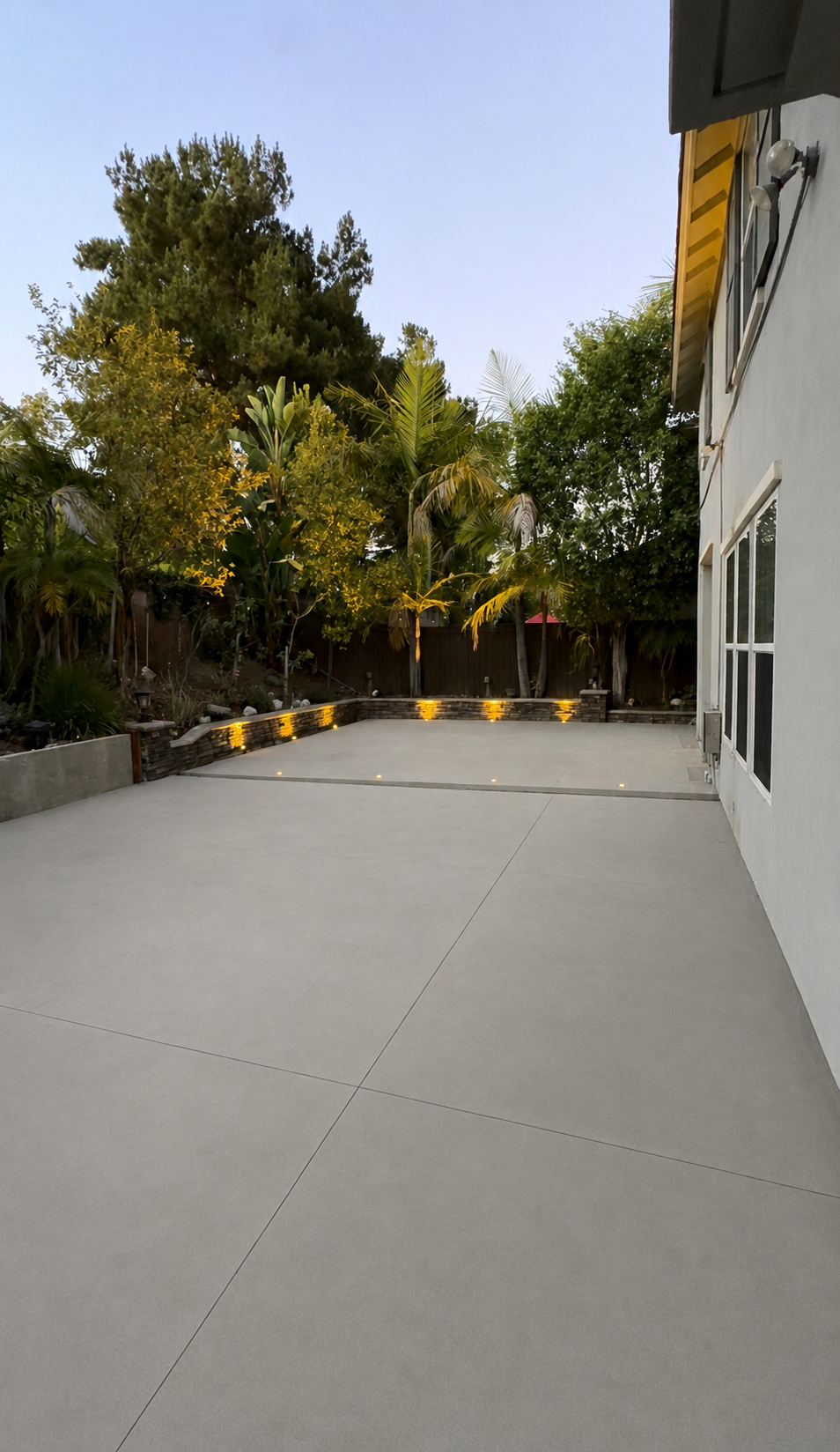 Contemporary Orange County home showcasing custom concrete hardscape and outdoor living design.