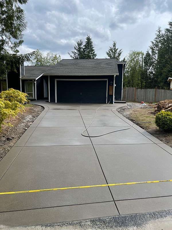 Completed concrete driveway replacement with reinforced construction and clean finish.