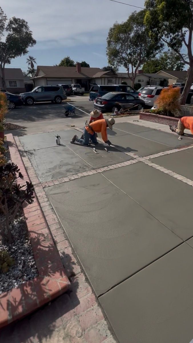 Concrete contractors using professional finishing techniques.