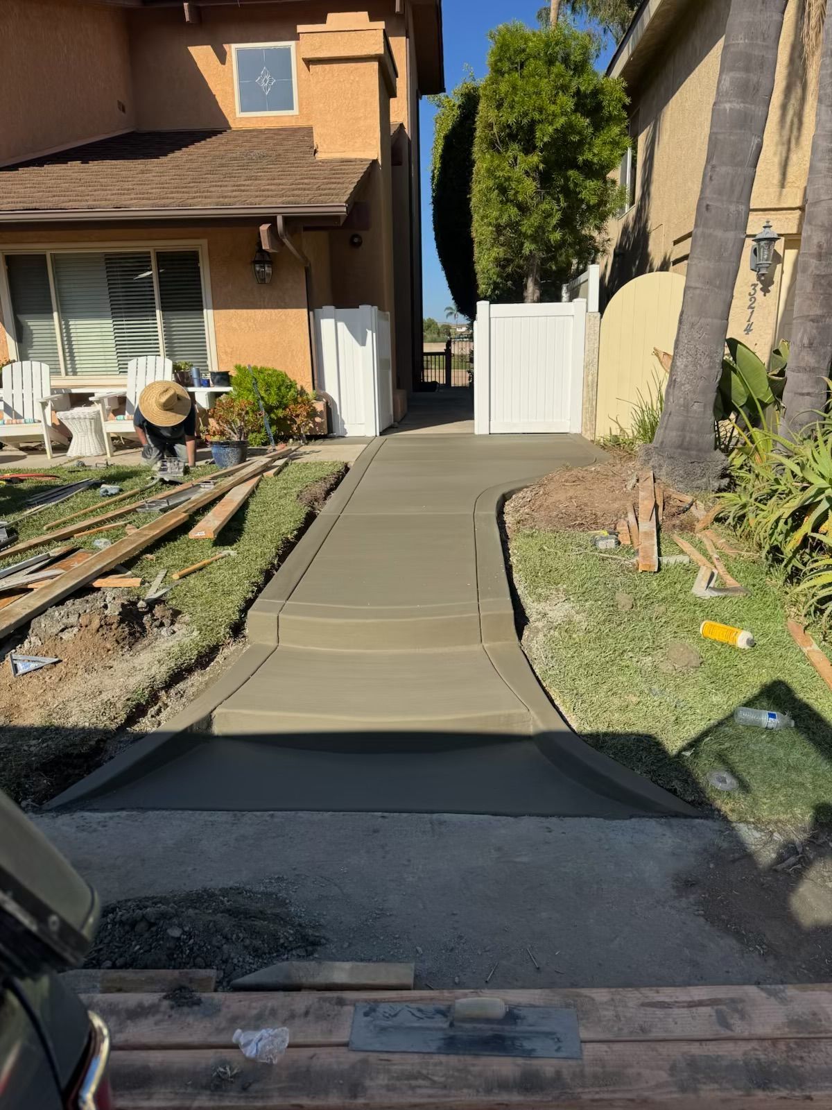 Finished residential concrete walkway connecting the front entrance and backyard.