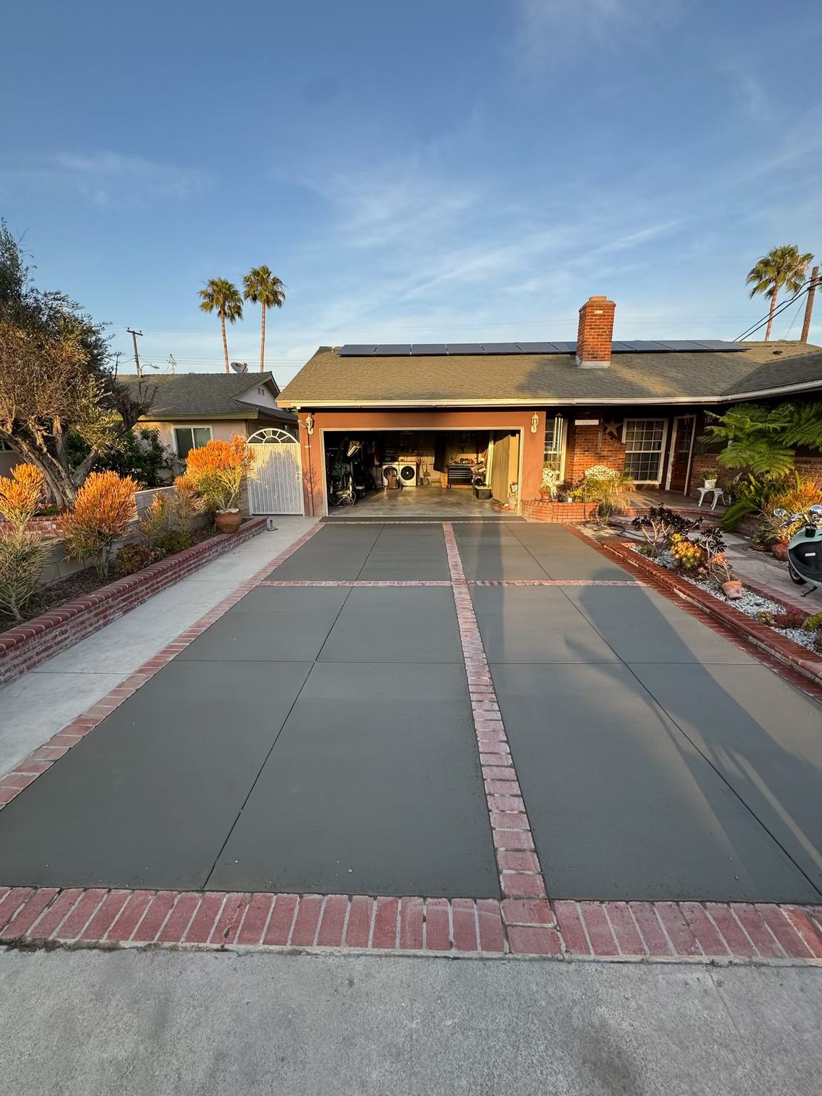New broom finish concrete driveway installed by Coastline Concrete in Orange County.