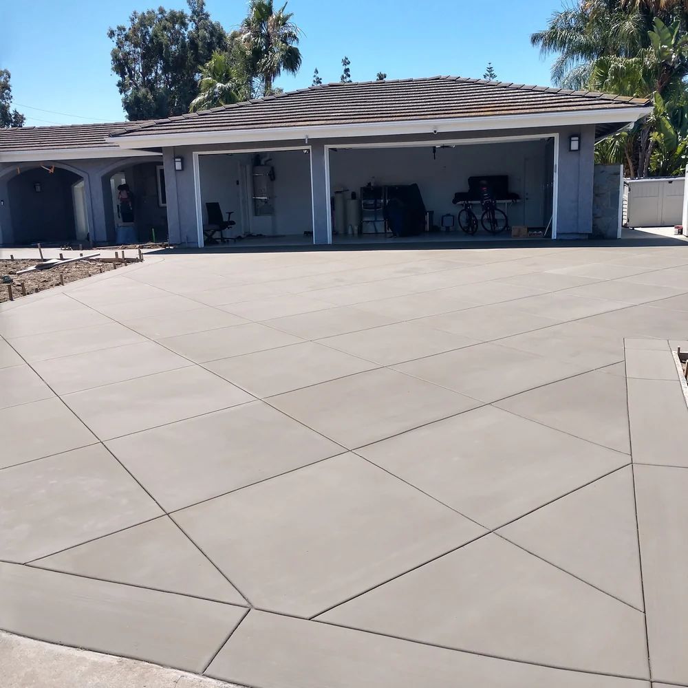 Completed concrete driveway replacement with reinforced construction and clean finish.
