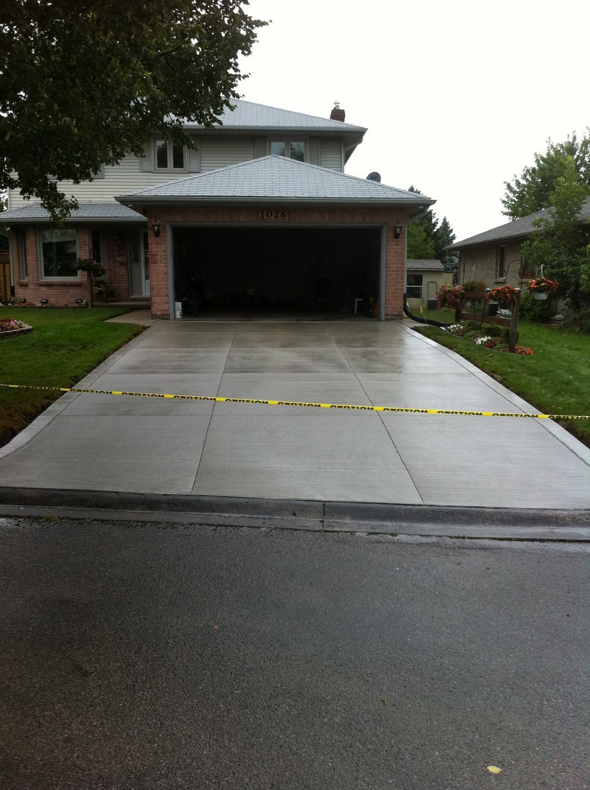 Completed concrete driveway replacement with reinforced construction and clean finish.