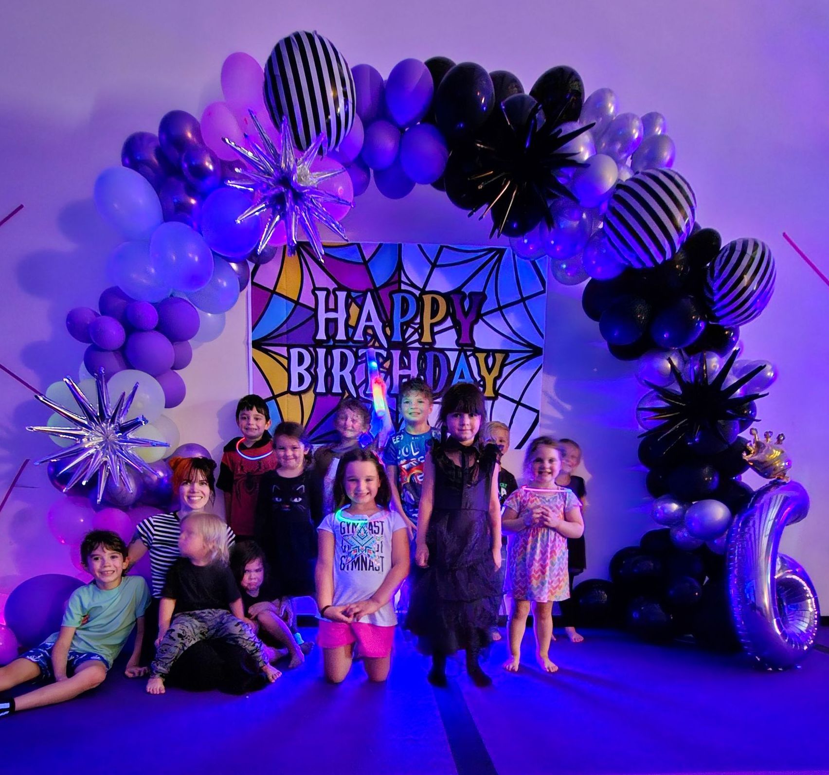 A group of children are posing for a picture at a birthday party.