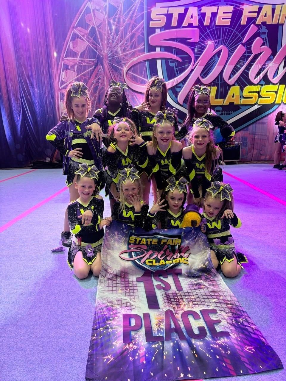 Two cheerleaders are posing for a picture together.