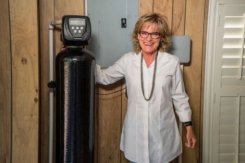 Leak — Woman Standing Next to a Water Filter in Austin, TX