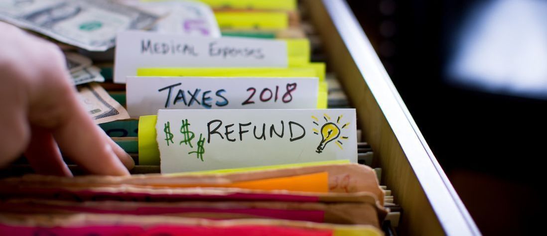 Filing cabinet with section on taxes and refunds in it