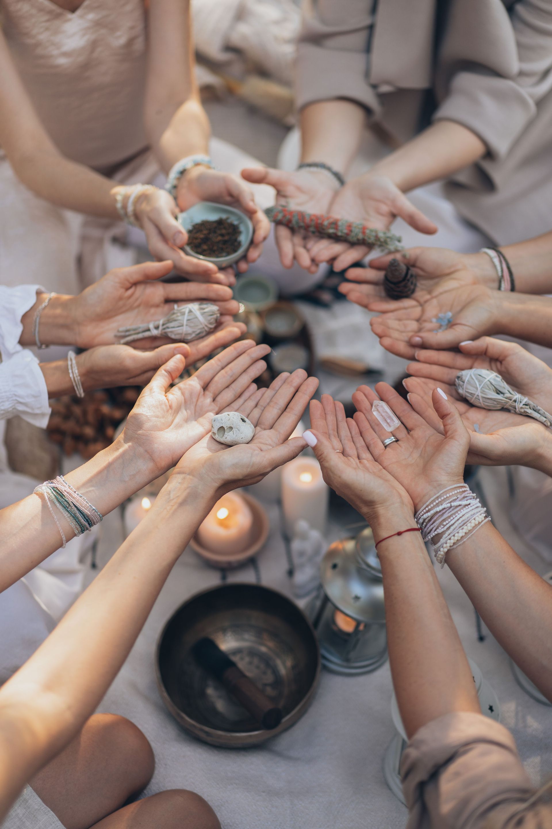 A group of women are sitting in a circle holding crystals in their hands — Marie McAneney In Walkervale, QLD