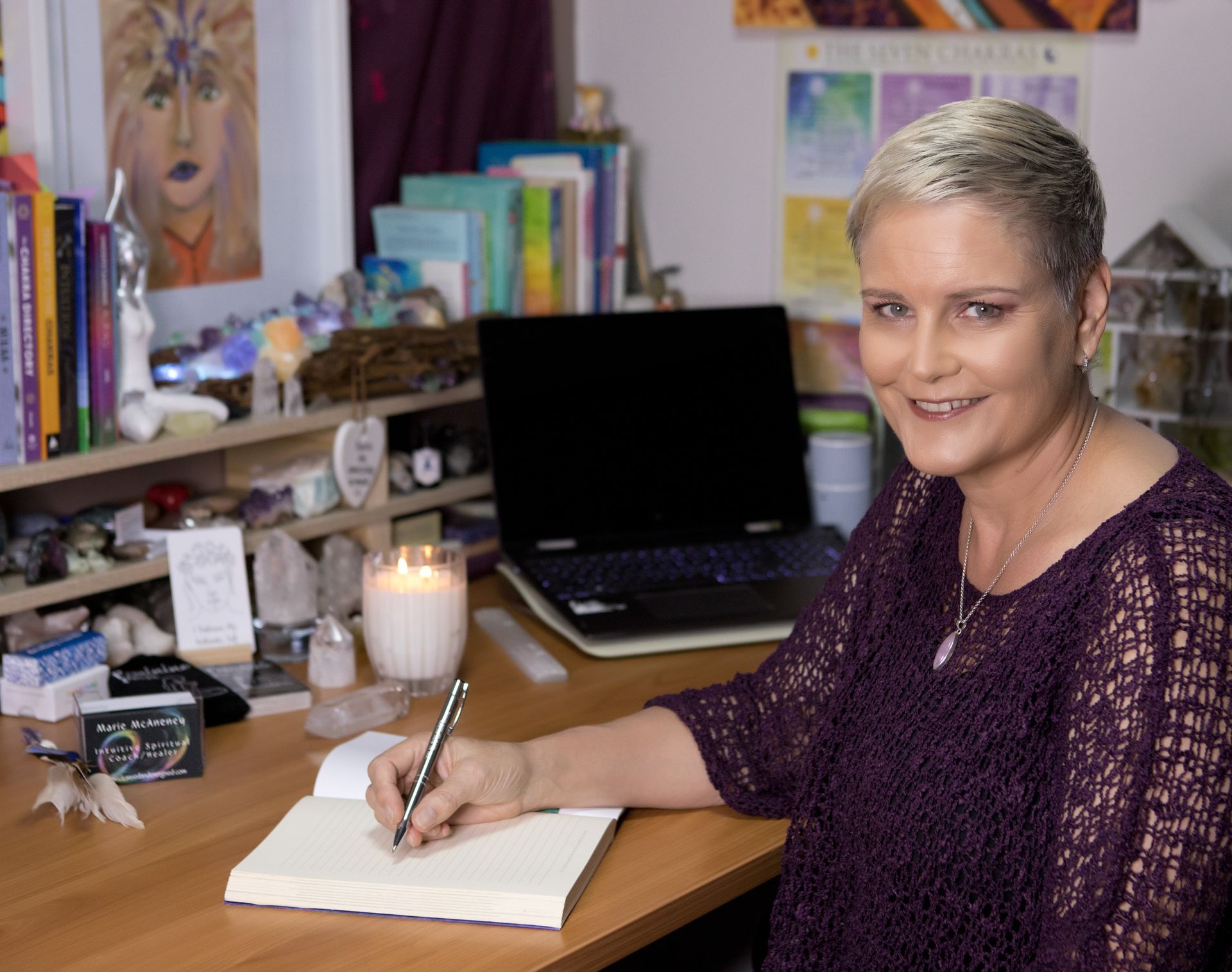 Woman Is Sitting In A Chair Writing in a Book — Marie McAneney In Walkervale, QLD