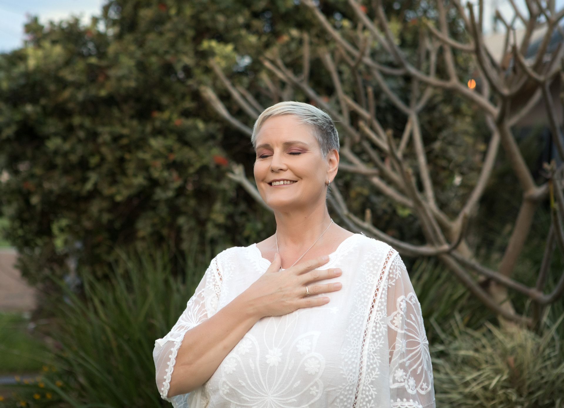 A Woman Is Putting Her Hand on Her Heart and Smiling — Marie McAneney In Walkervale, QLD