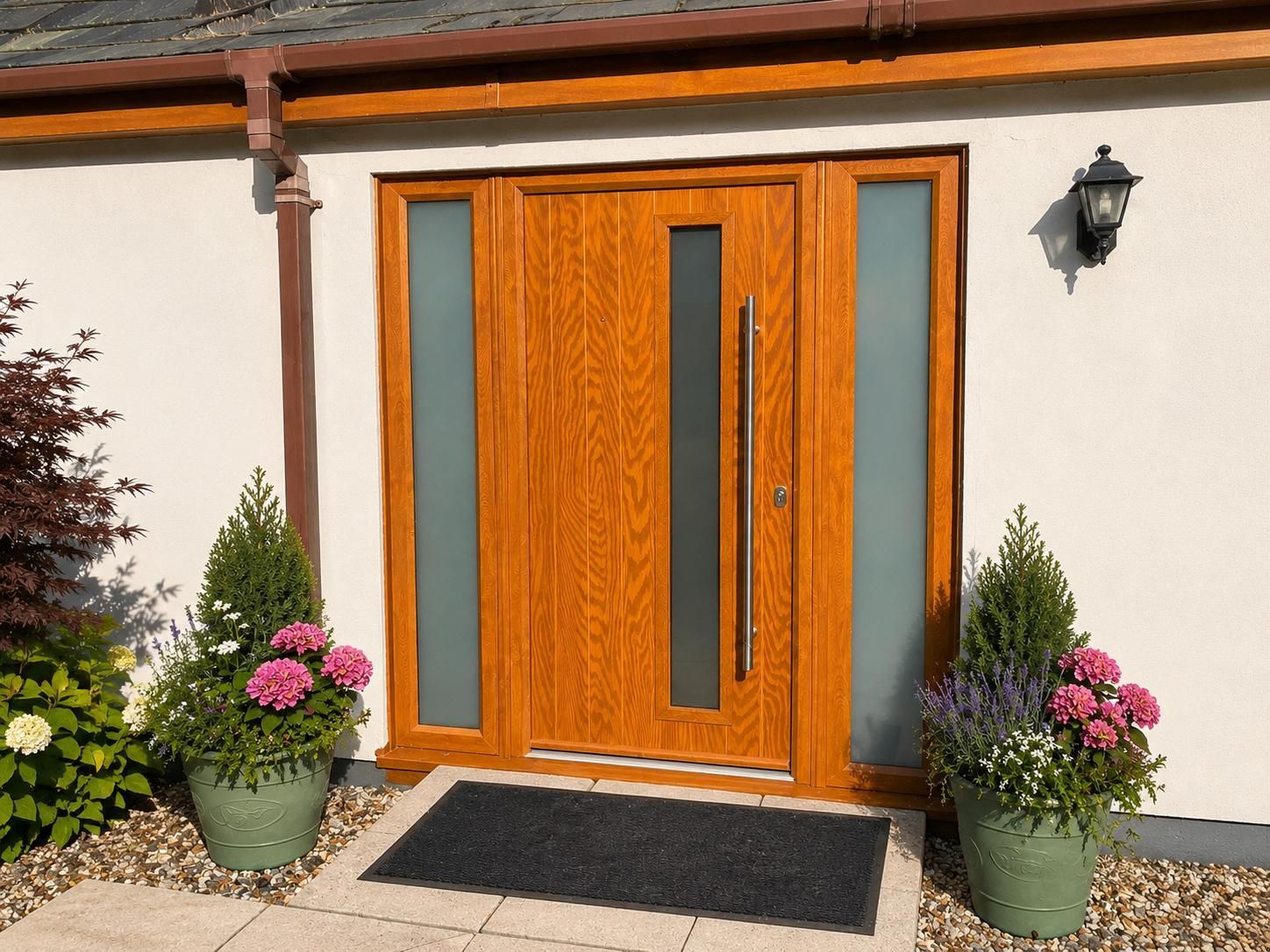 Golden Oak  composite front door with chrome hardware installed by C4W in Pembrokeshire.