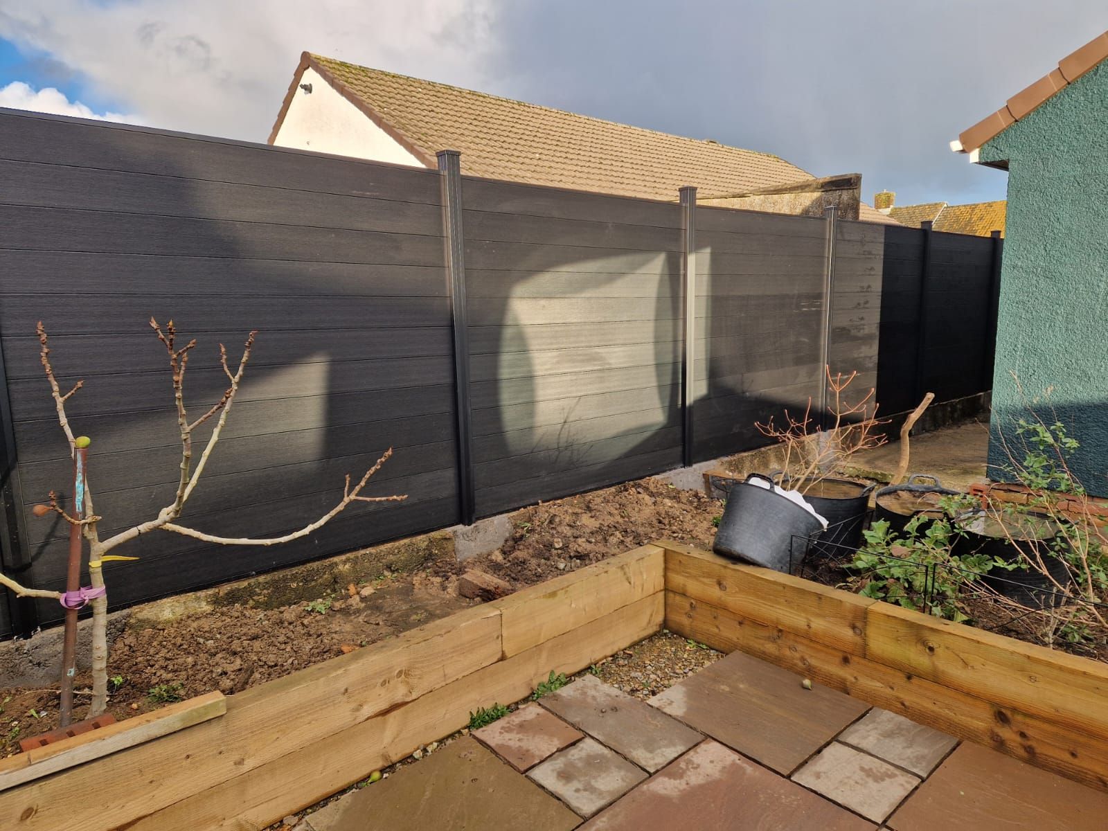 Composite fencing panels installed with matching posts in a Pembrokeshire garden.