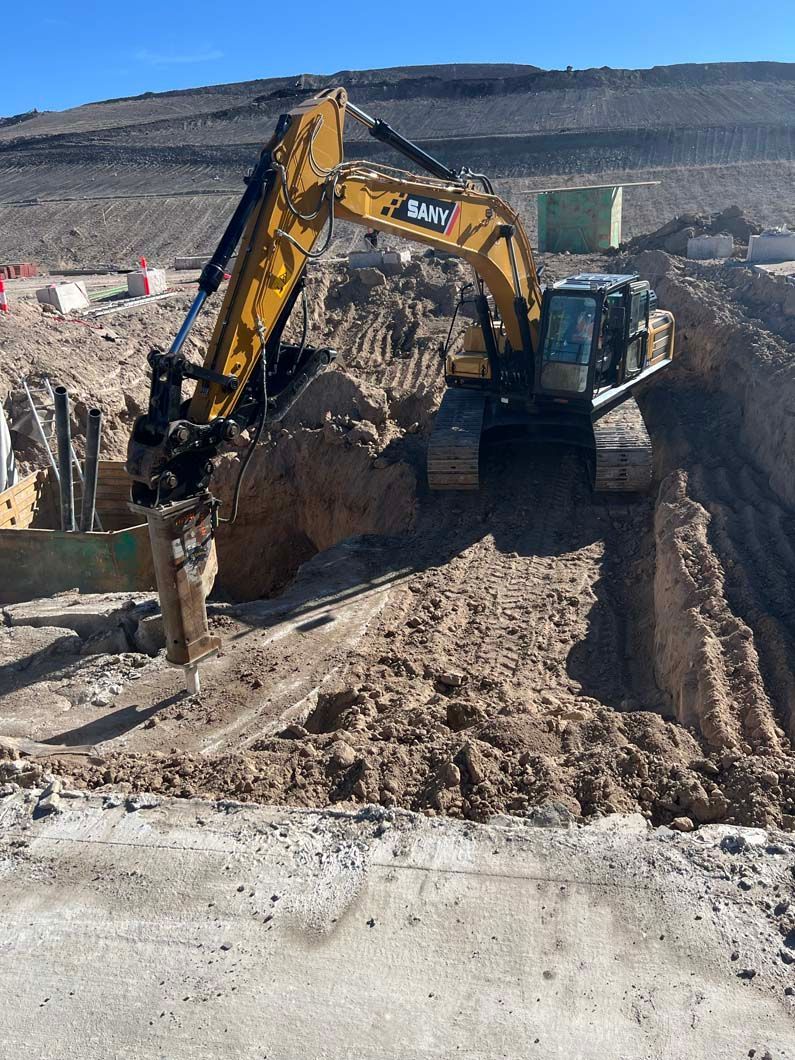 A large excavator is digging a hole in the dirt.