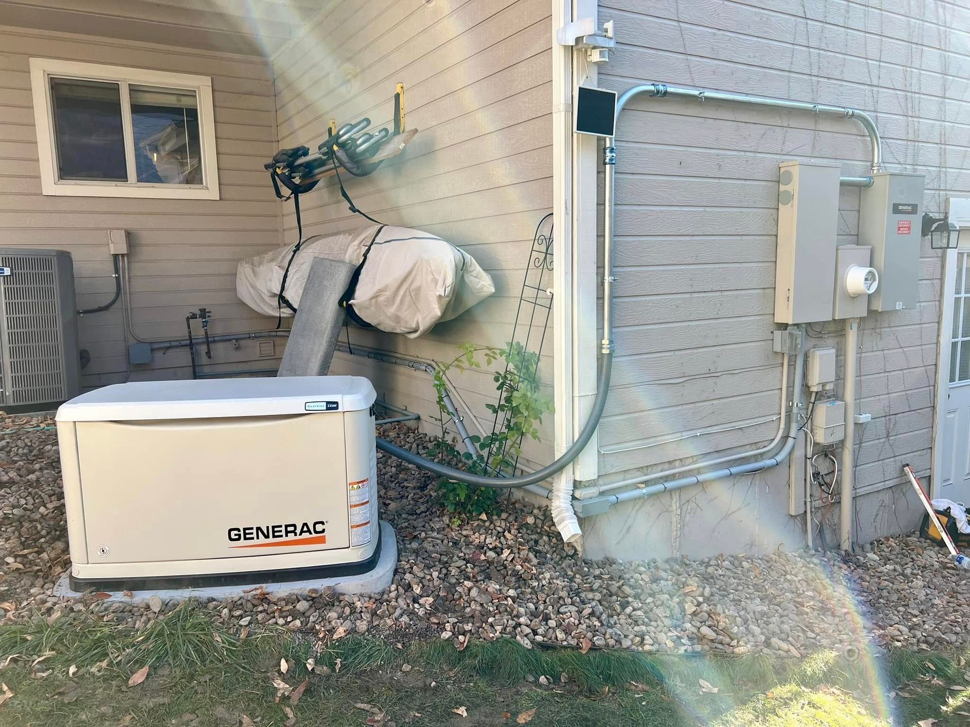 Snowy scene with items on a tarp next to a cabin and truck.