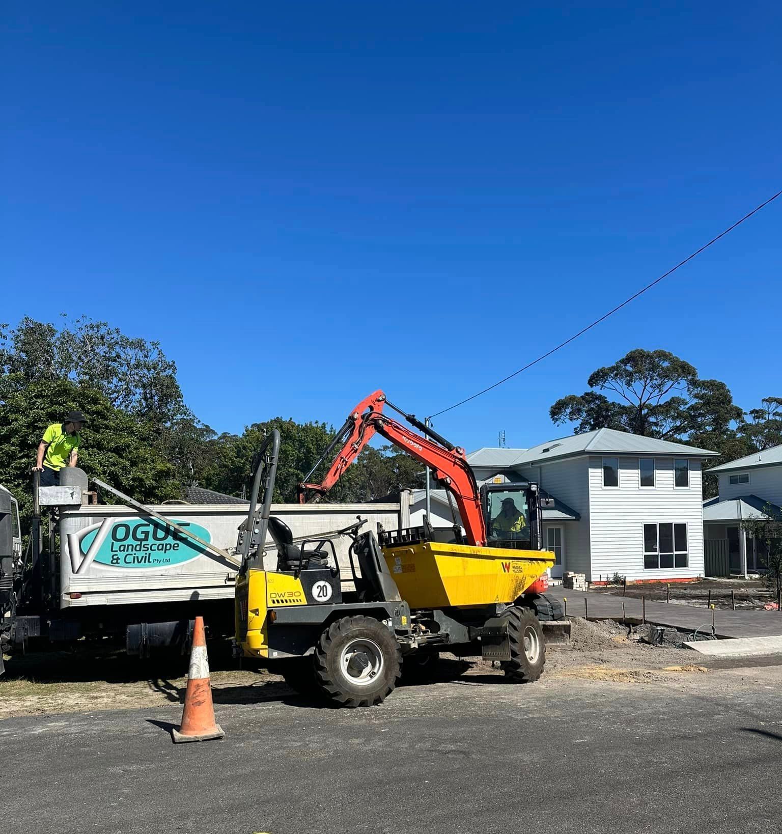 A construction site with a dump truck and an excavator.