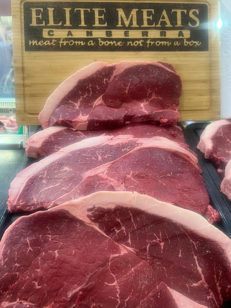 A Tray of Meat with a Sign that says elite Meats — Elite Meats in Holt, ACT