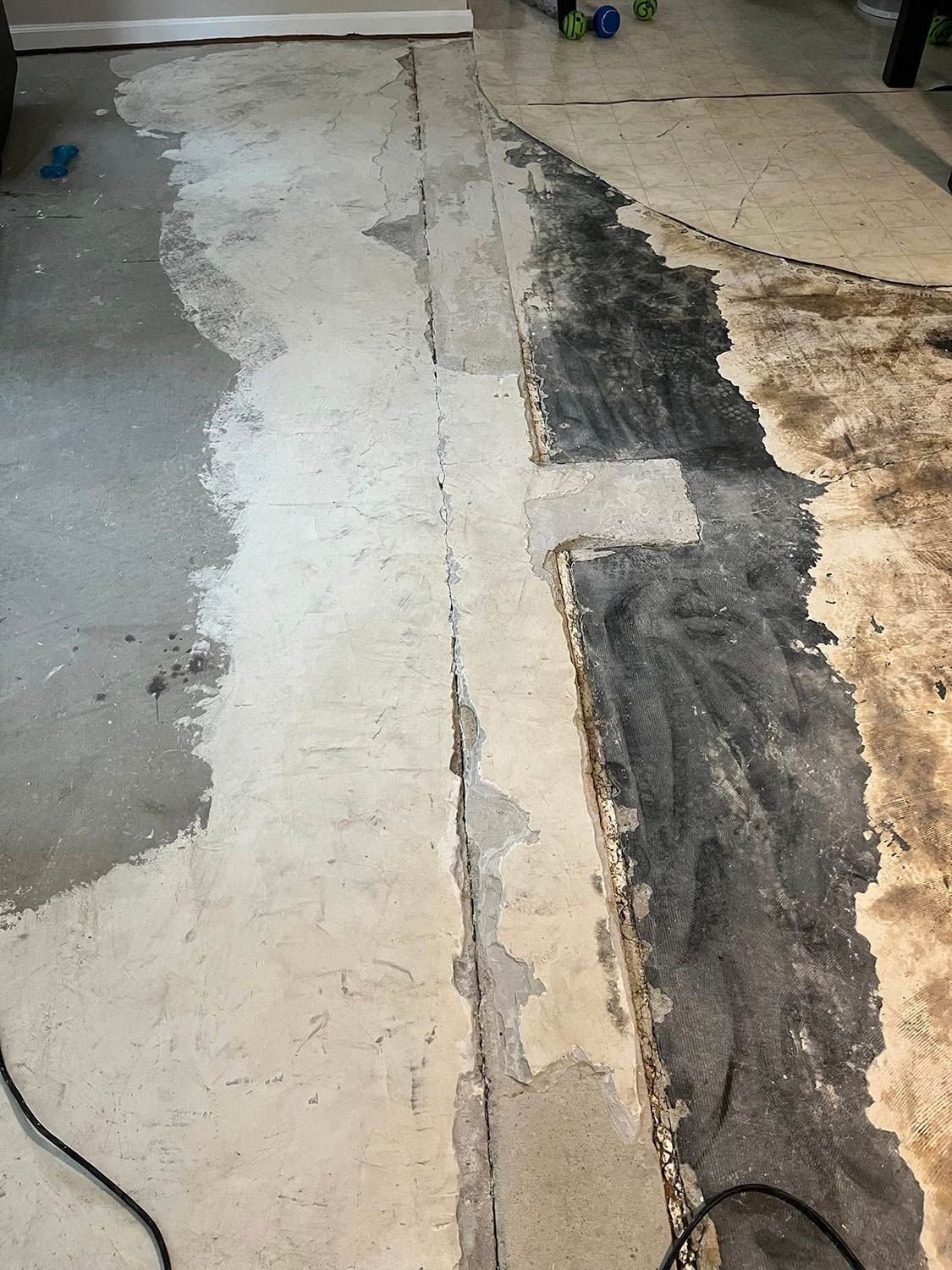 Concrete floor with sections of old flooring removed