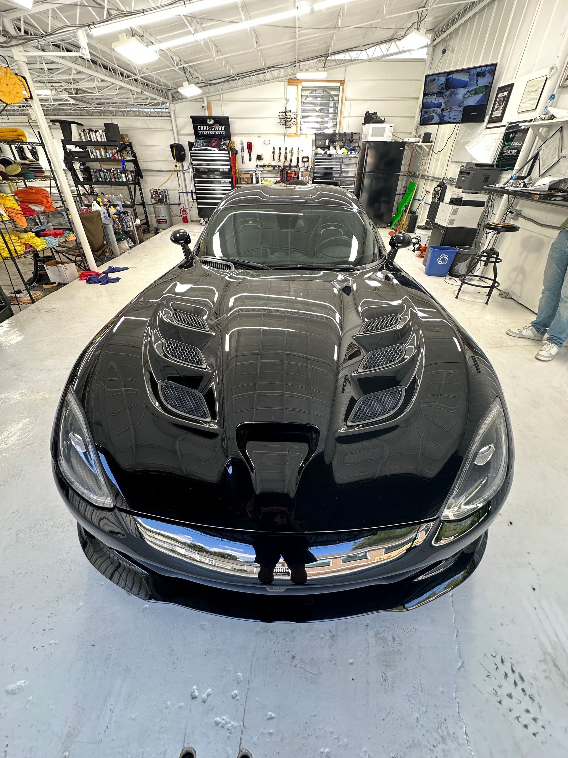 Side-by-side comparison of paint protection film and ceramic coating being applied to a car.