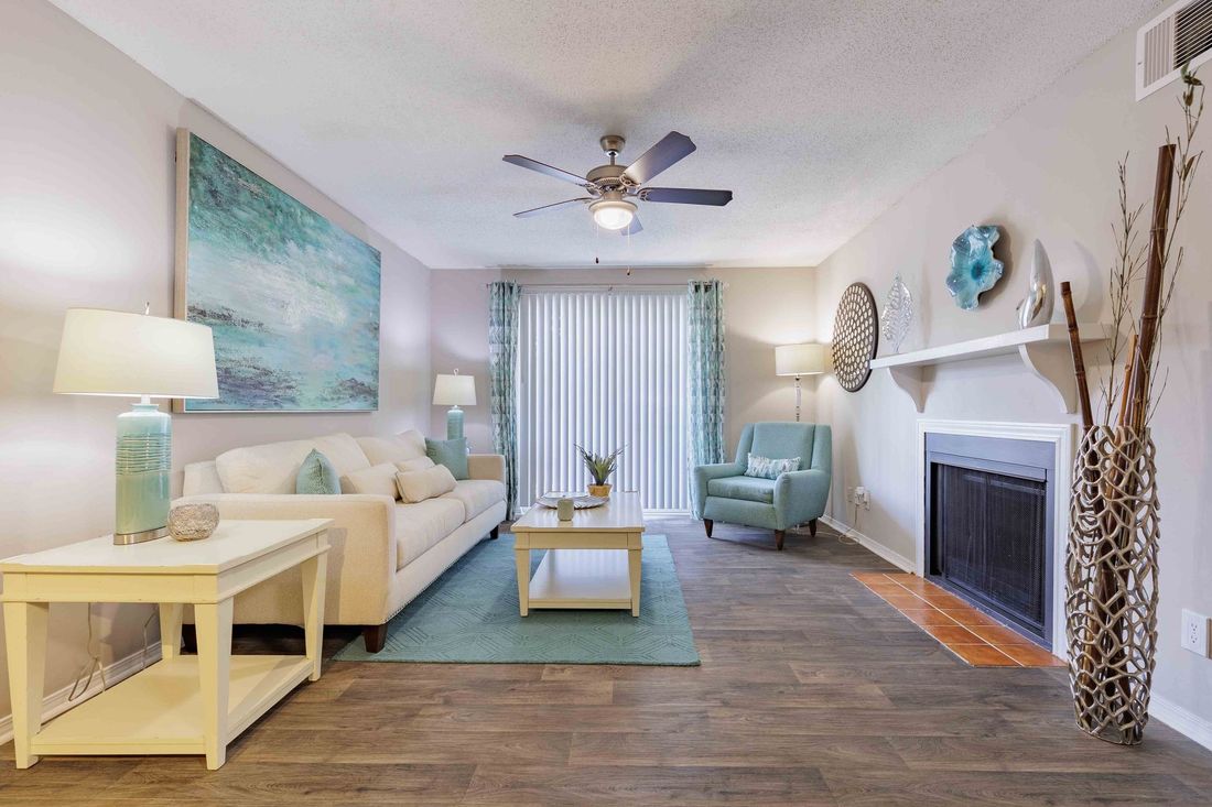 Aerial view: Lush green trees dominate a residential area, with a body of water visible in the distance.
