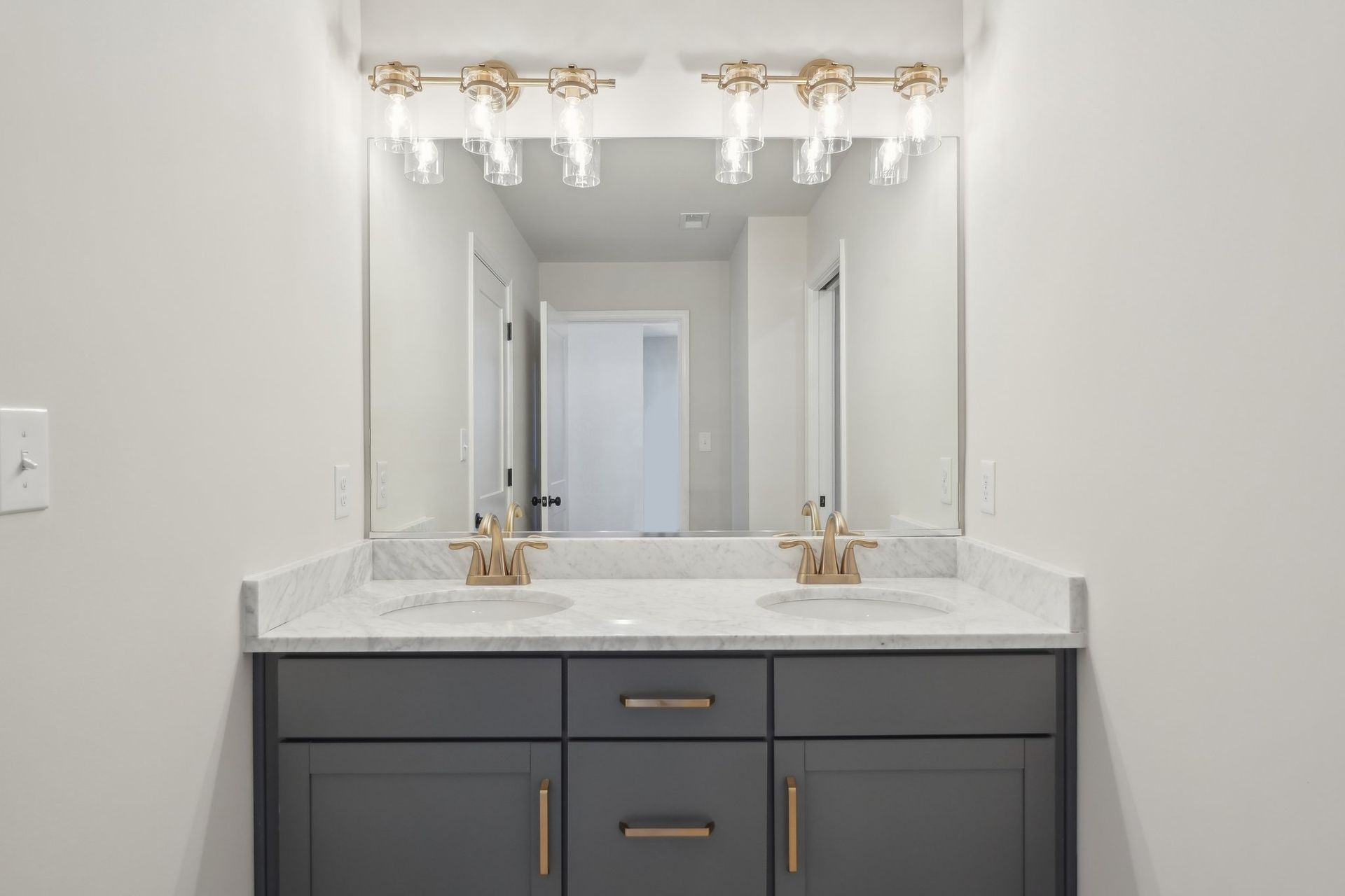 A bathroom with two sinks and a large mirror.