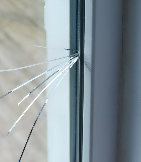 A Close up Of a Broken Glass Window in A Room — Boambee Gauze 'n' Glass in Harbour, NSW
