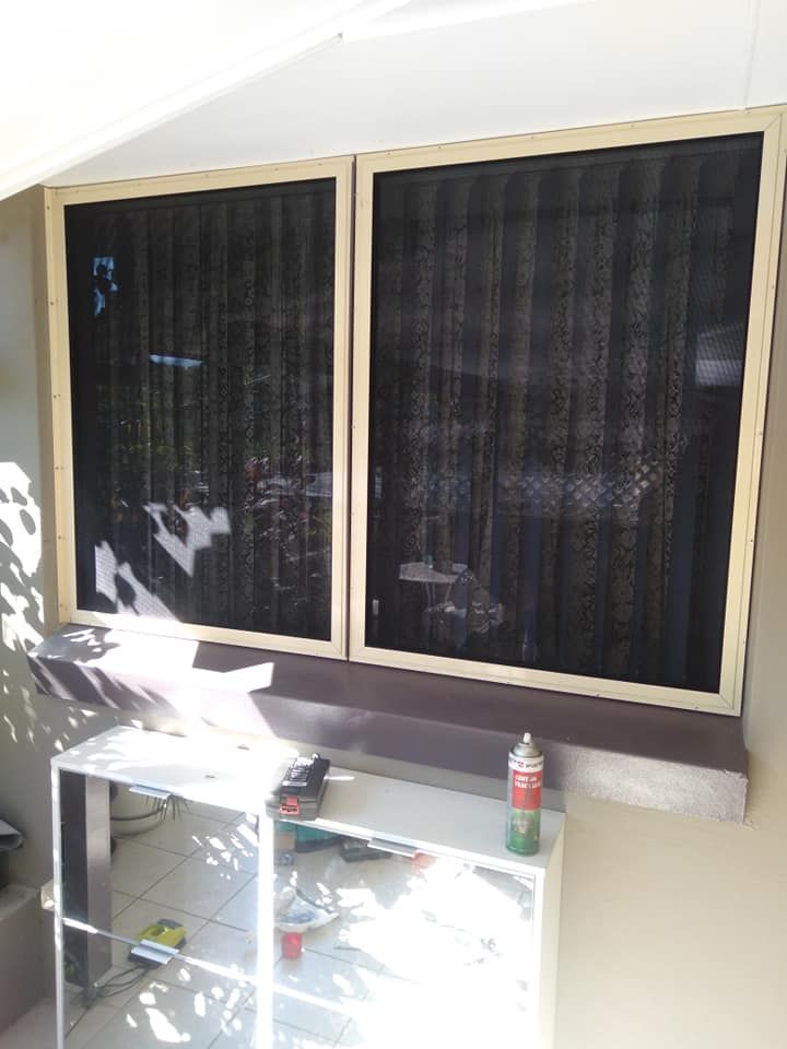 A shelf with a bottle of gas next to a window.