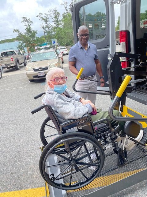 Doctor holding pill bottles, explaining medication to a patient in a medical office.
