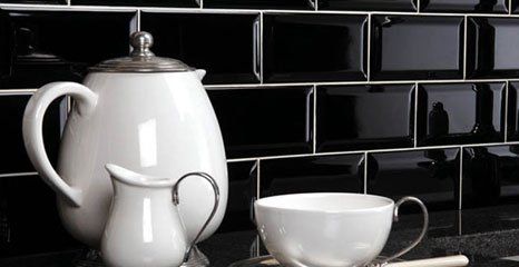 White china set against glossy black tiles