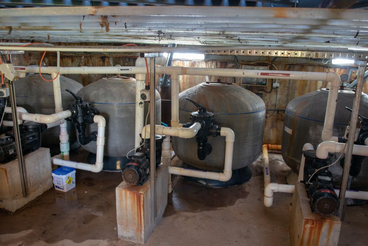 A Room with A Lot of Pipes and Tanks in It — Figleaf Pool Products in Coconut Grove, NT