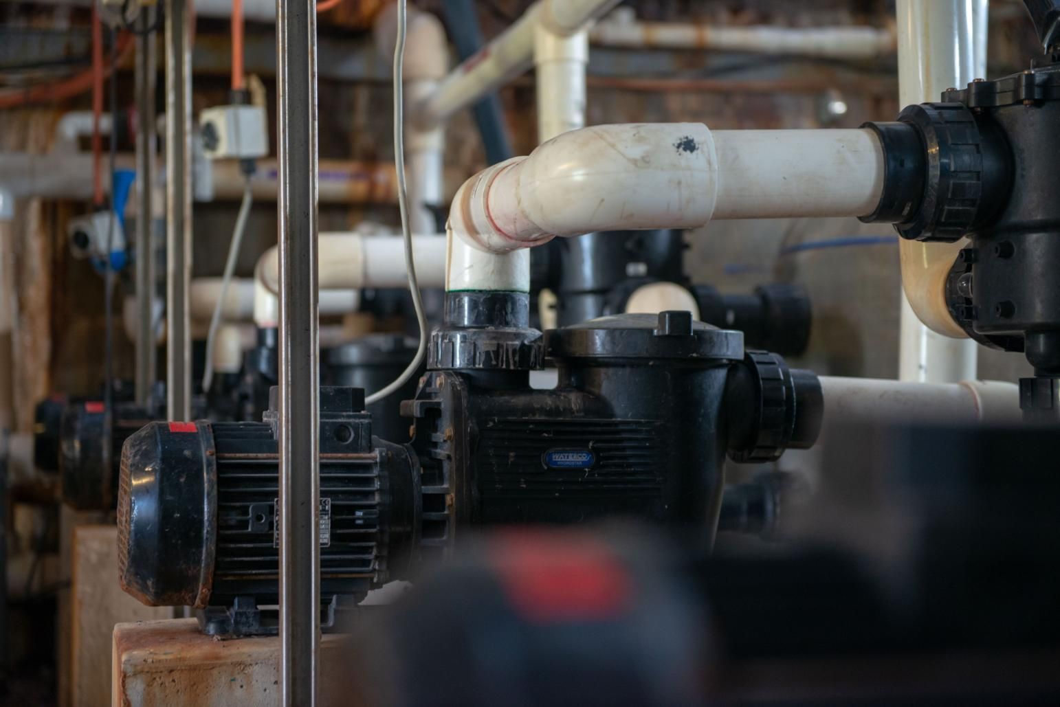 A Row of Pumps and Pipes in A Factory — Figleaf Pool Products in Coconut Grove, NT