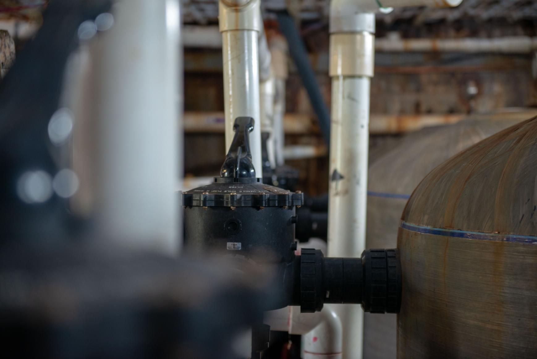 A Bunch of Pipes Are Connected to Each Other in A Room — Figleaf Pool Products in Coconut Grove, NT