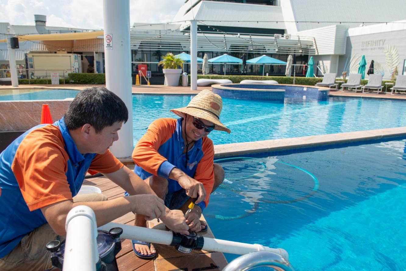 Two Men Are Working on A Swimming Pool — Figleaf Pool Products in Coconut Grove, NT