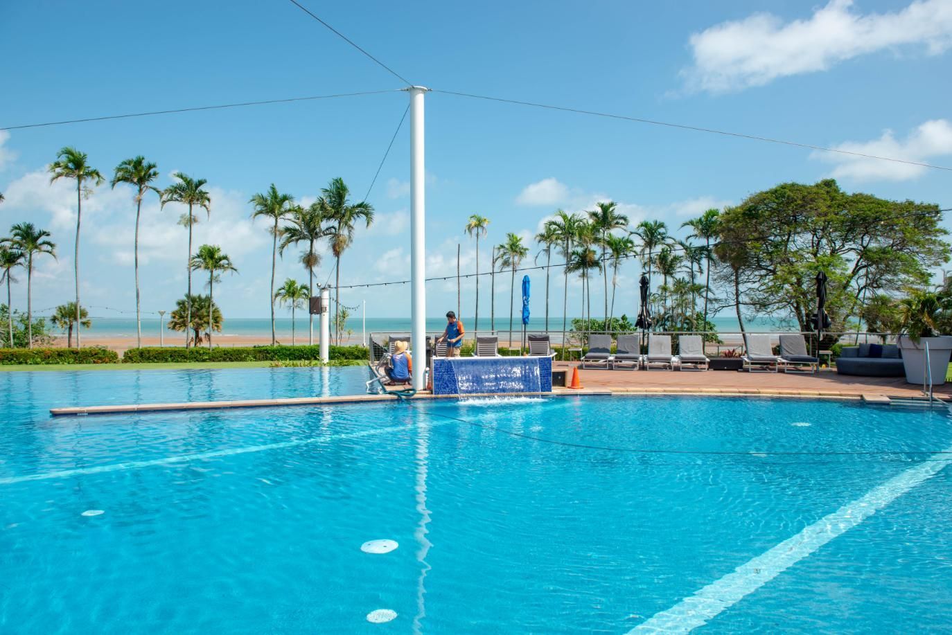 A Large Swimming Pool with Palm Trees in The Background — Figleaf Pool Products in Coconut Grove, NT