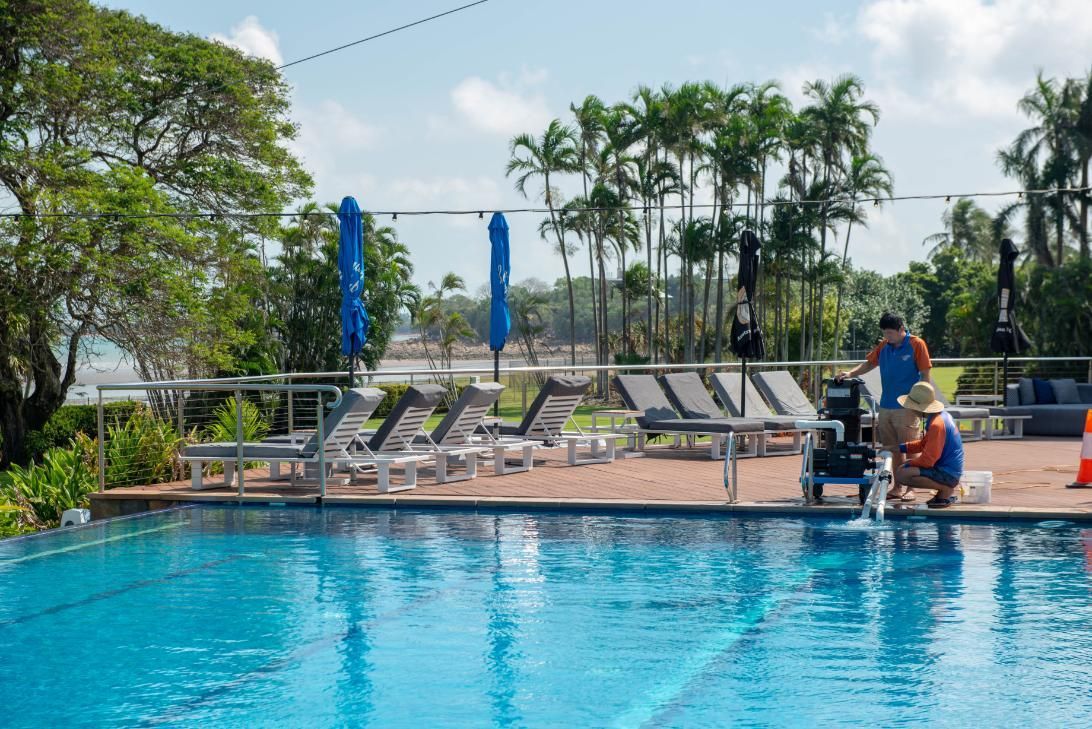 A Man in A Wheelchair Is Standing Next to A Swimming Pool — Figleaf Pool Products in Coconut Grove, NT