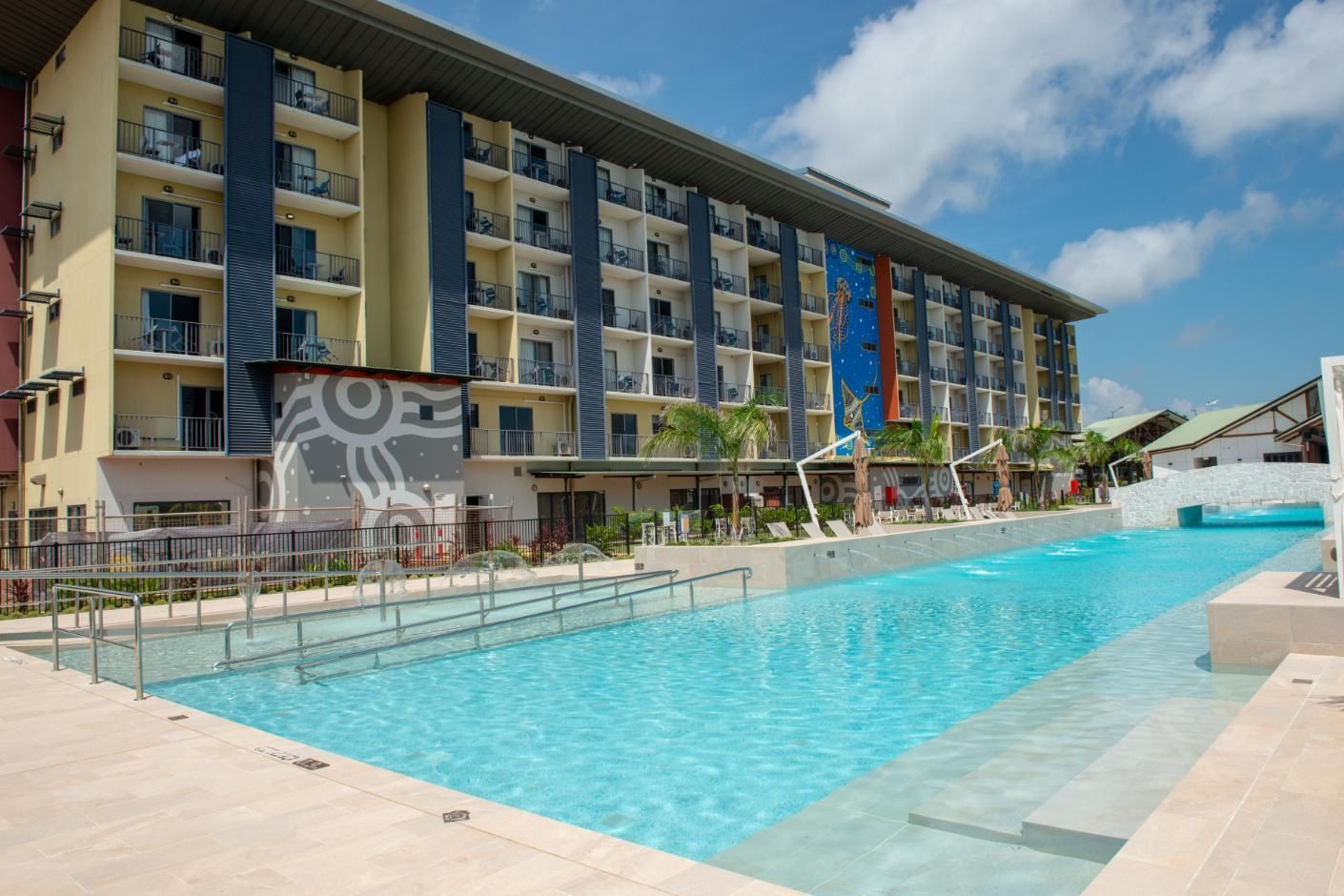 A Large Building with A Swimming Pool in Front of It — Figleaf Pool Products in Coconut Grove, NT