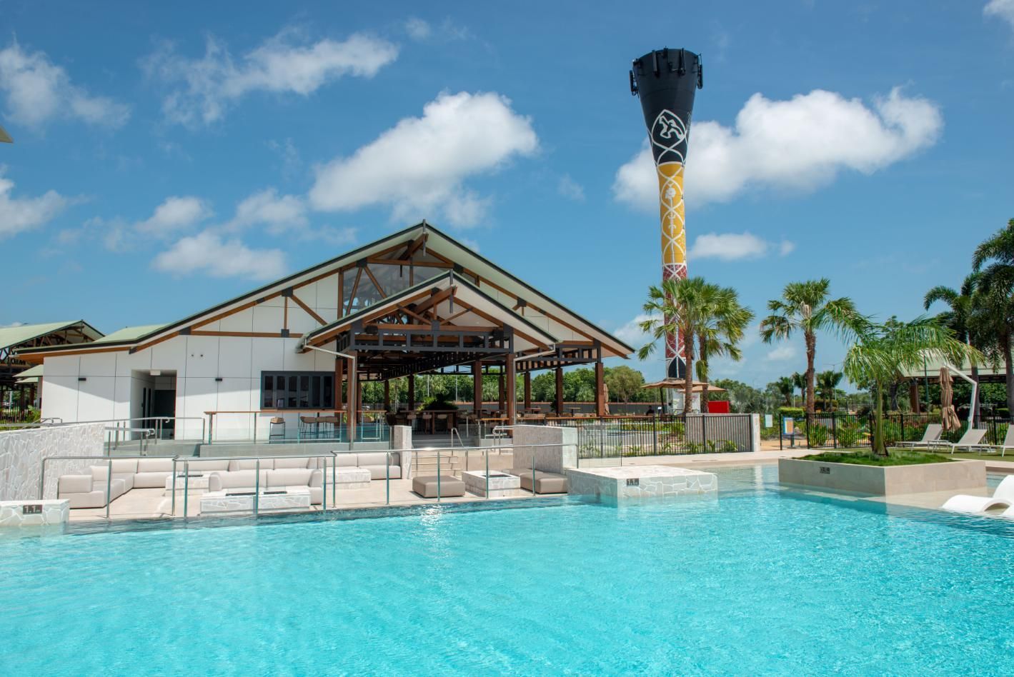 A Large Swimming Pool with A Building in The Background — Figleaf Pool Products in Coconut Grove, NT