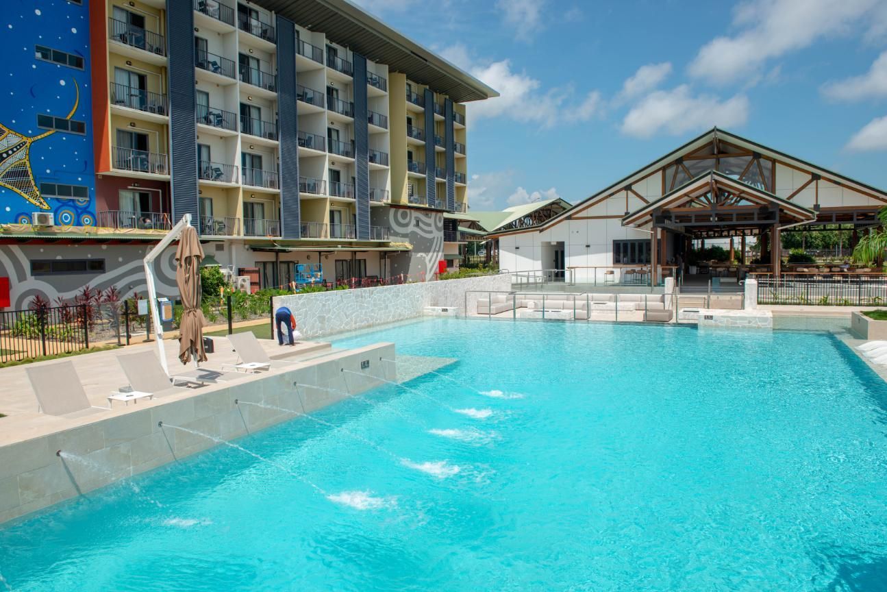 A Person is Holding a Test Kit in Front of a Swimming Pool — Figleaf Pool Products in Coconut Grove, NT