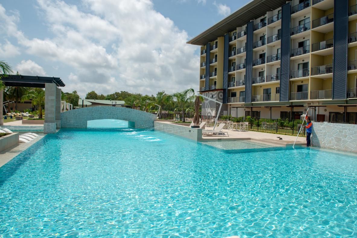 A Large Swimming Pool with A Canopy and Chairs Around It — Figleaf Pool Products in Coconut Grove, NT