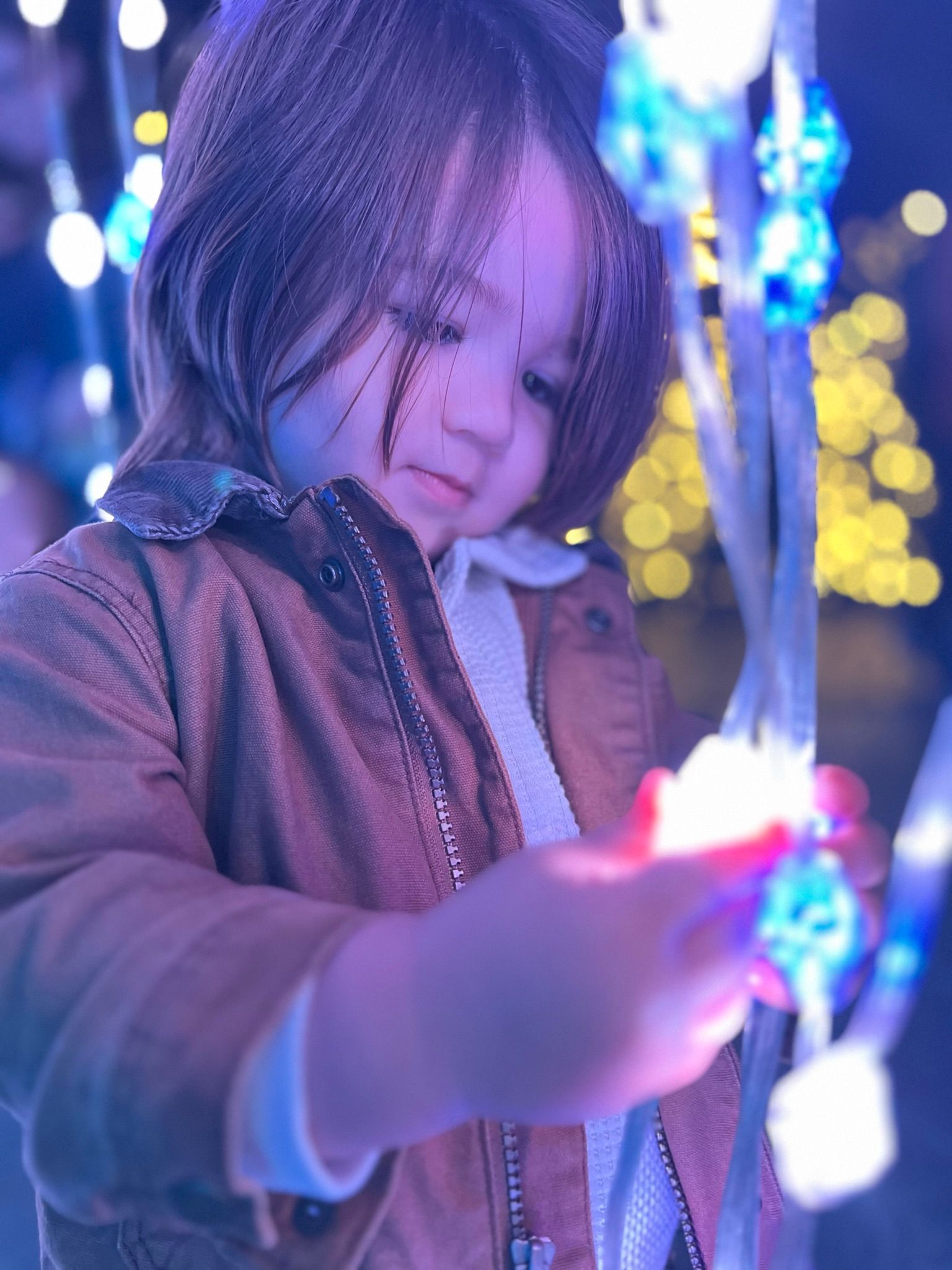 Little girl holding a glowing object
