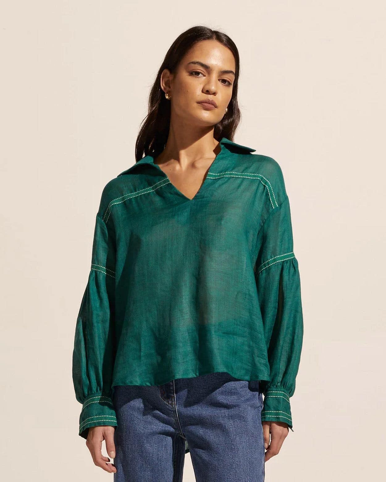 a Woman is Wearing a Green Shirt and Blue Jeans — Montaze In Erina, NSW
