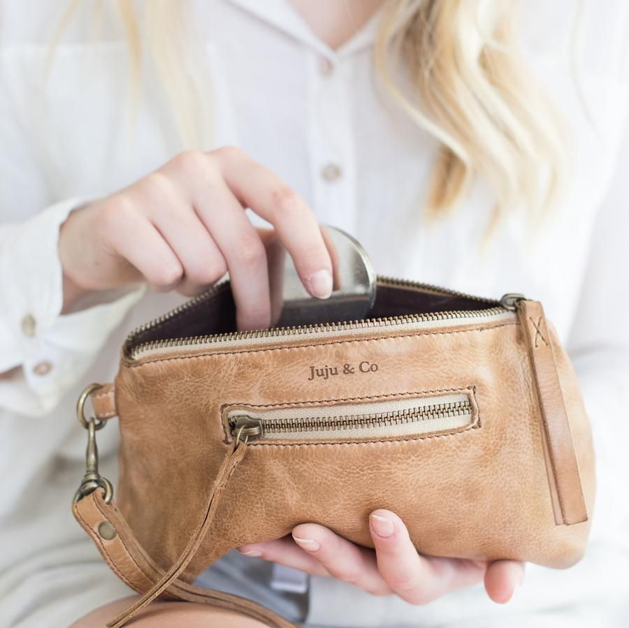a Person is Holding Three Different Colored Leather Clutches — Montaze In Erina, NSW